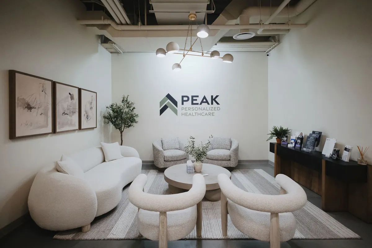 Peak patient lounge with soft seating and the Peak logo