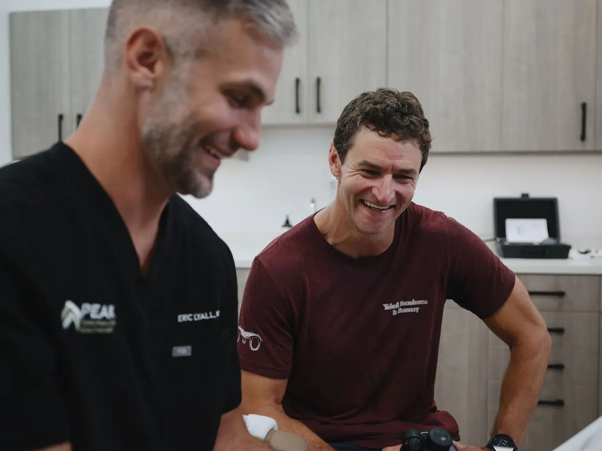 Dr. Lyall and a patient laughing during a results consultation