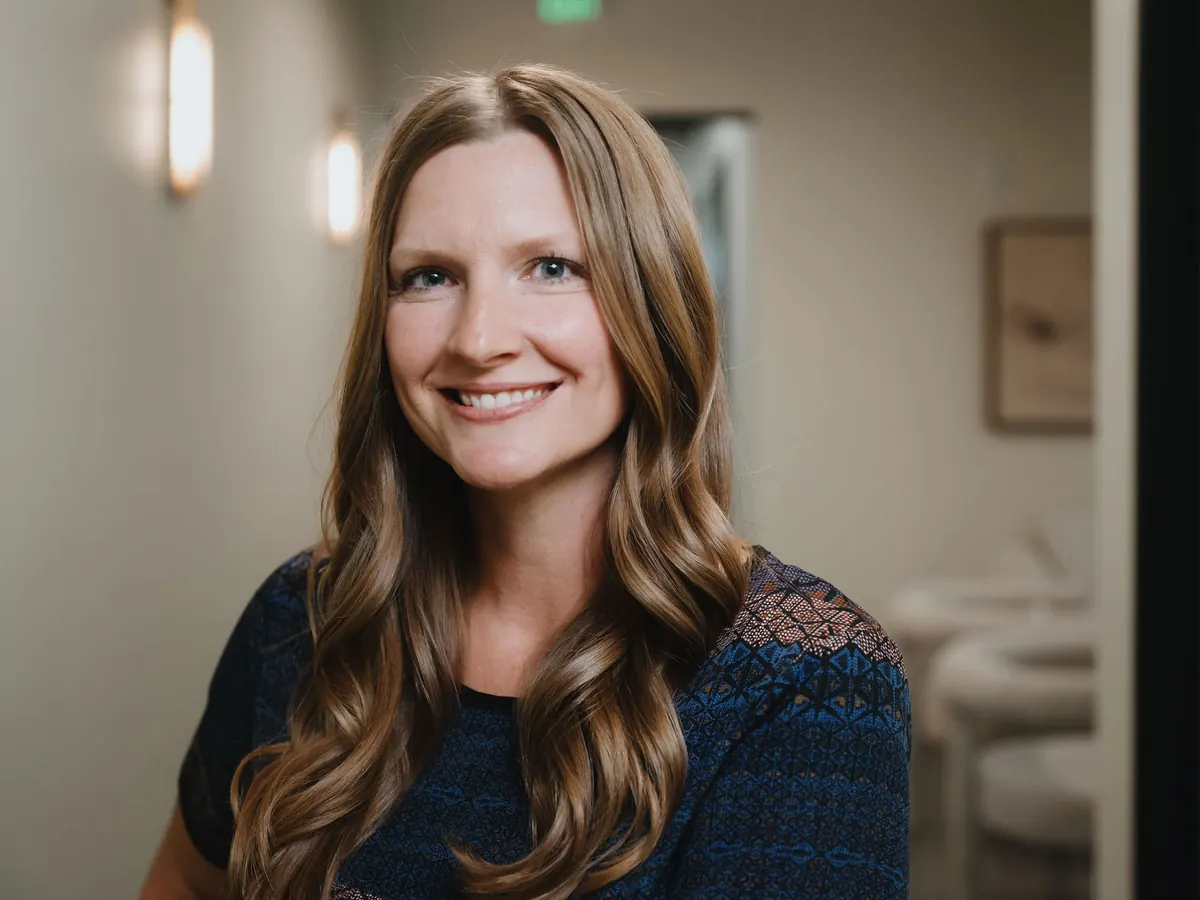 Smiling patient in the hallway at Peak Personalized Healthcare